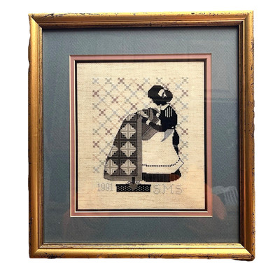 Vntg 1991 framed cross stitch sampler style of woman making quilt SMS (Sanborn)
