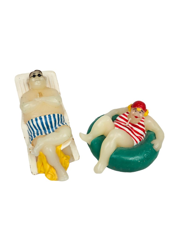 Kitschy mid-century novelty candles shaped like sunbathers in innertubes — the kind of retro beach kitsch that looks great on a shelf and actually makes people laugh.