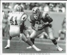 1990 Press Photo Buford McGee and player Wilson face off at football game