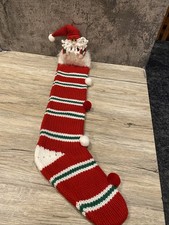 Vintage red and white knit Christmas stocking with Santa on top