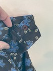 Black County Seat ladies shirt size M with blue and yellow flower print, buttoned cuff, and “Made in USA” label.