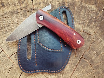 Friction folder pocket knife with Mopane handle and leather sheath