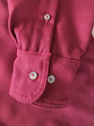Filson virgin wool guide shirt with long sleeves, button front, and two white buttons on the cuffs.