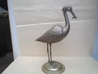 Large early 20th century Alpaca silver stork catching fish with amber eyes
