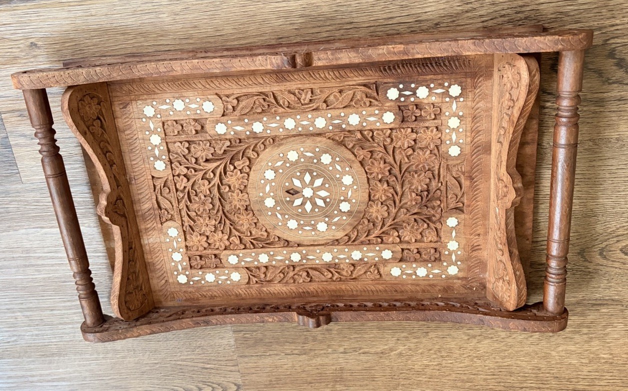 Brown carved wood serving tray with handles and floral carving