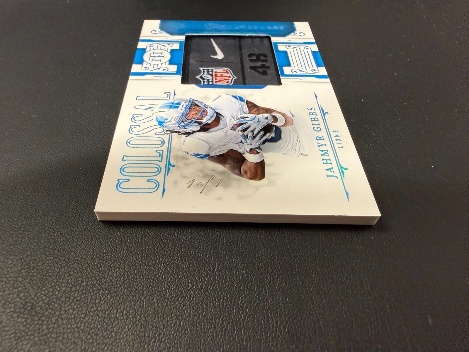 2025 National Treasures Jahmyr Gibbs 1/1 NFL Shield Nike Swoosh Colossal Patch view 3