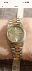 Seiko Quartz Day/Date Two-Tone Metal Bracelet Analog Silver Dial Dress Watch