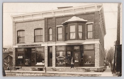 RPPC Postcard West Carthage NY Balmat & Brayton Grocery Hardware Store Barber