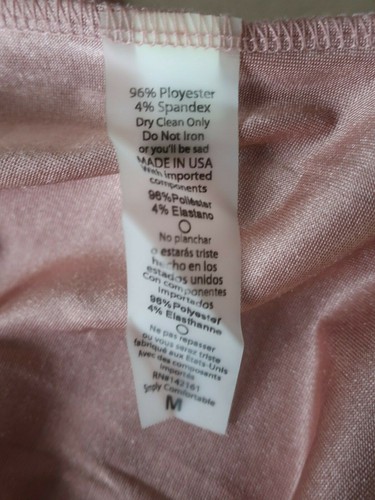 White fabric tag on pink satin EUC LuLaRoe Rose Gold cover up jacket with black text reading “Made in U.S.A.”