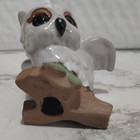 vintage ceramic owl bird figurine on log branch with green leaves — photo 4