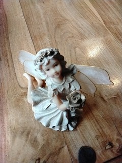 Ceramic Fairy Ornament Holding Flower