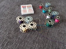 Twelve VTG 10 Hole Metal Sewing Bobbins w/Varied Colored Threads and Needles