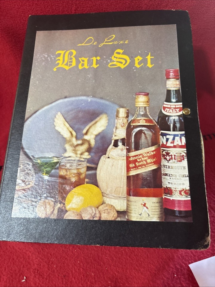 A complete 1970s Japanese bar tool set housed like a book — opens up to reveal mixing tools and a cocktail recipe guide.