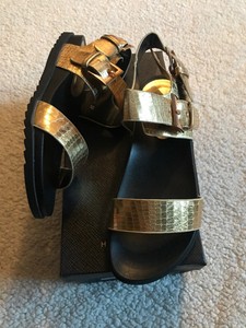 black and gold flatforms