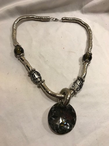 metallic necklace with glass beads and large black pendant