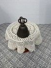 Antique silver Gilchrist Turnkey Type ice cream scoop with black metal bowl and white lace-patterned tablecloth.