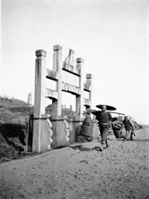 Wuhan China, men carrying baskets past roadside monument OLD PHOTO
