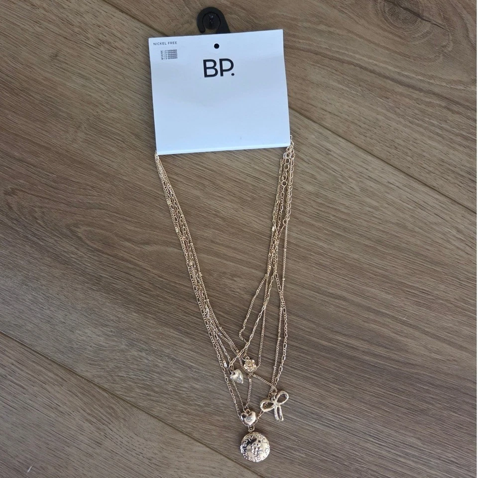 Juego de collar en capas sin níquel BP tono dorado arco corazón medallón flores dijes NUEVO Foto 3 de 4