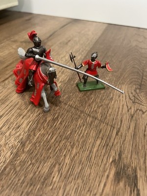 Britain s mounted medieval night jousting red coat brown horse 54 mm