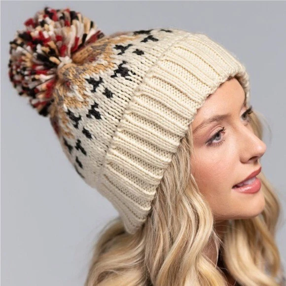Cream winter hat shop with pom pom