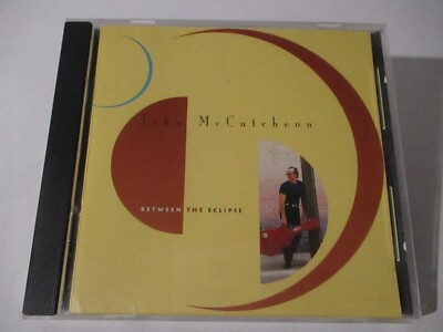 John McCutcheon Between The Eclipse CD 1994 Rounder Records Hole Punch UPC