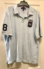 light blue Tommy Hilfiger polo shirt features a distinctive embroidered crest