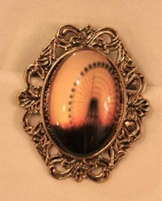 Handsome Festoon Rim Bow Top Goldtone Ferris Wheel Against the Sky Brooch Pin