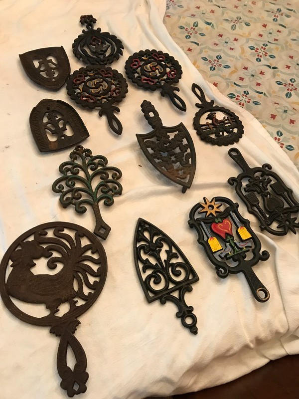 LOT OF 12 CAST IRON TRIVETS ASSORTED
