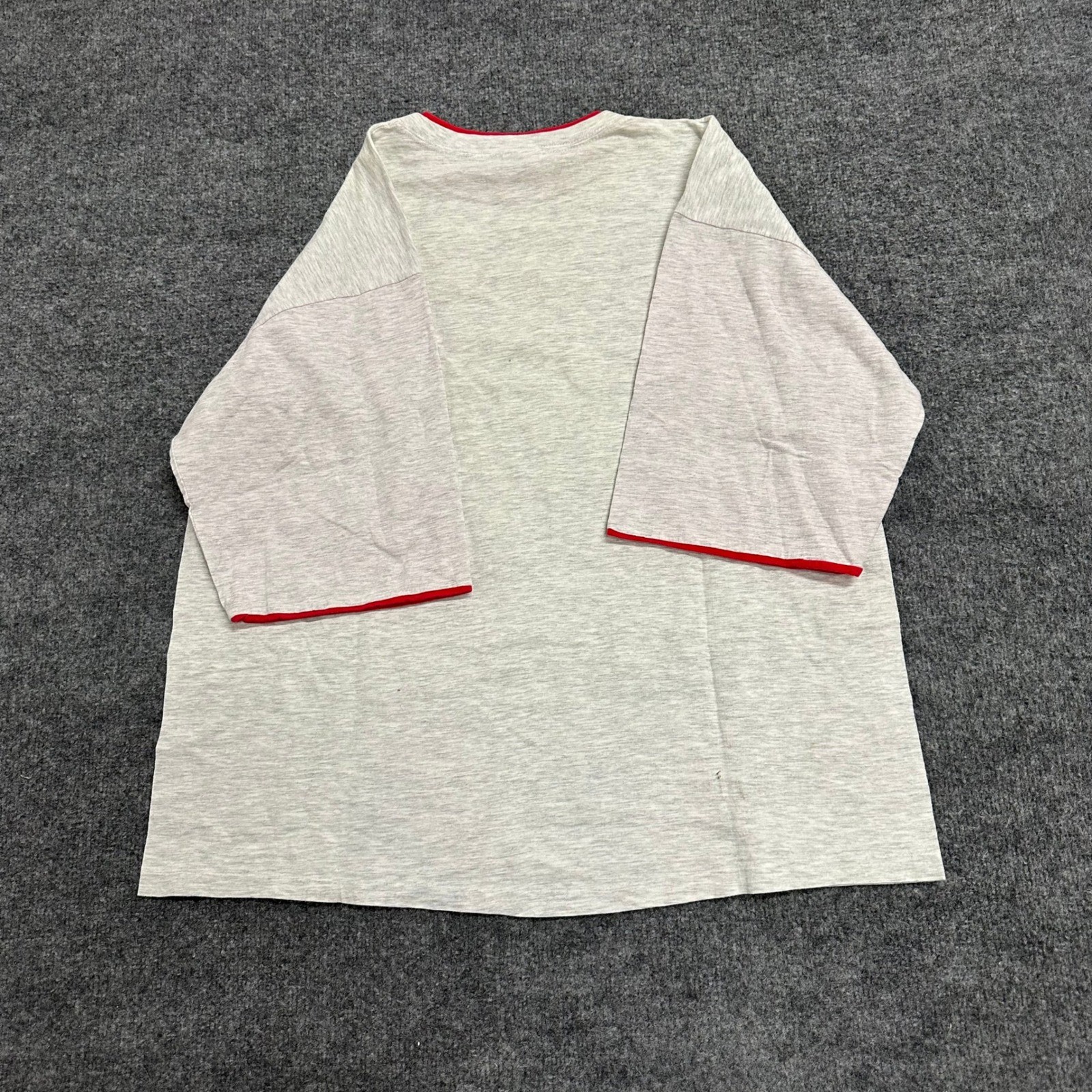 Grey Alore men’s T-shirt XXL with red-trimmed sleeves and back, laid flat on a textured dark grey surface.