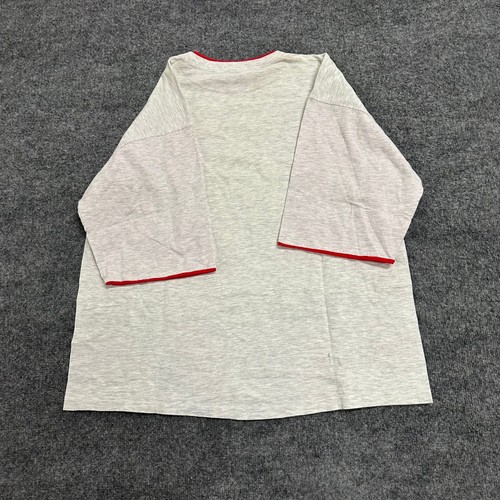 Grey Alore men’s T-shirt XXL with red-trimmed sleeves and back, laid flat on a textured dark grey surface.