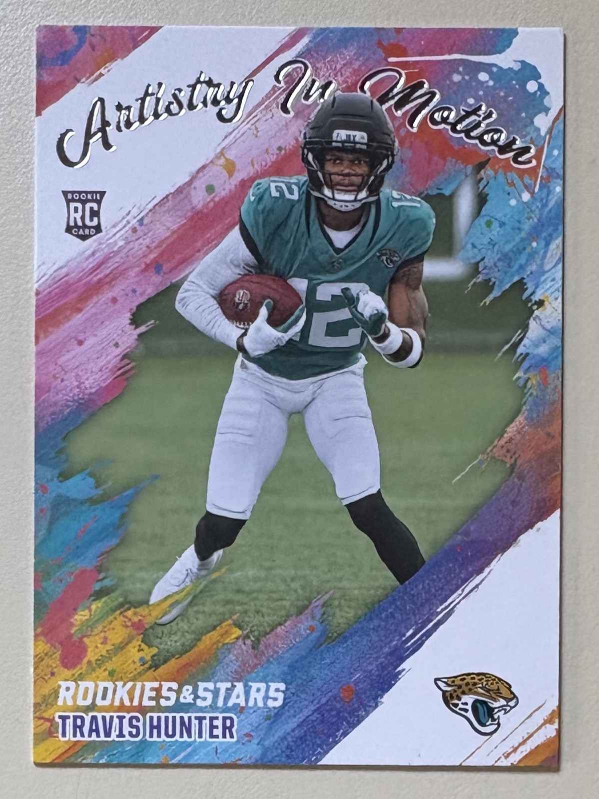 2025 Panini Rookies & Stars - Artistry in Motion Travis Hunter #8 (RC)