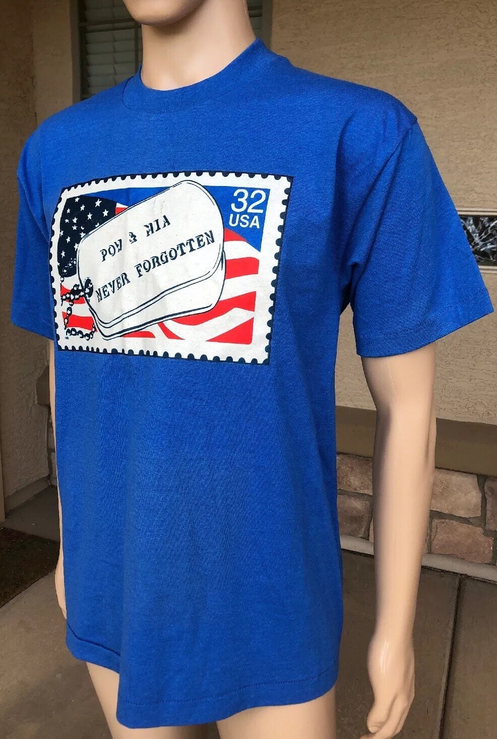 Blue EUC vintage 1995 T-shirt with red, white, and blue POW MIA Never Forgotten stamp and USA flag graphic.