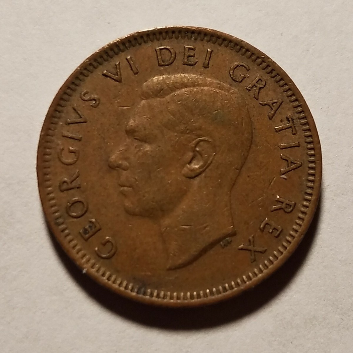1949 Canadian penny with King George VI on front and maple leaf on