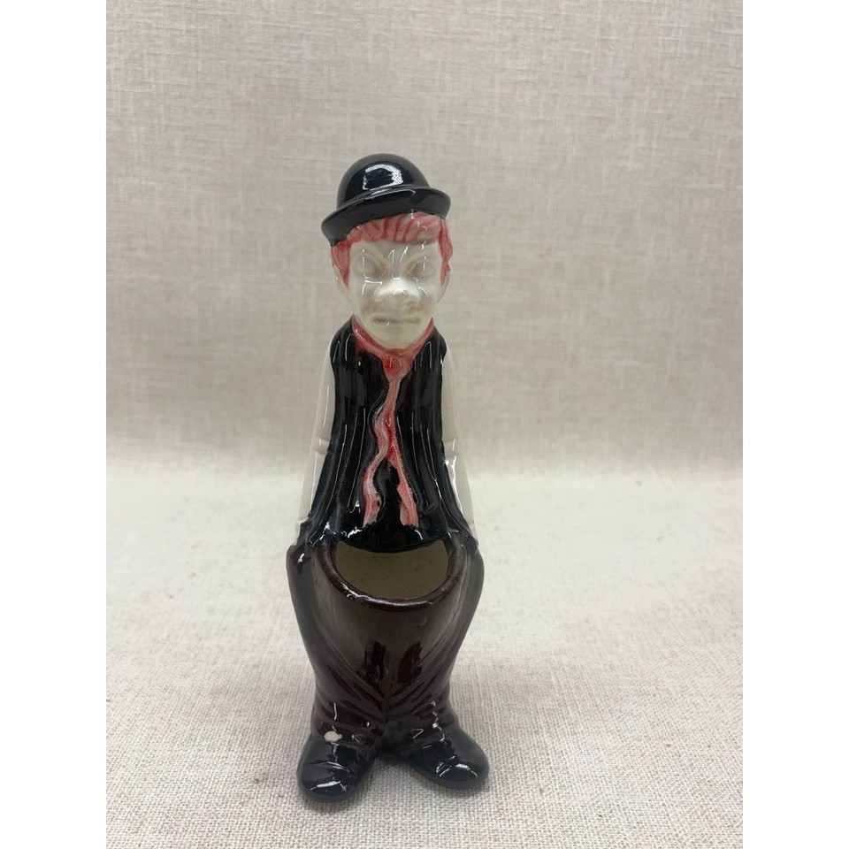 A kitschy vintage ceramic hobo clown pocket ashtray/match holder — the kind of gloriously weird mid-century knick-knack that looks perfect on a bar cart or bookshelf.