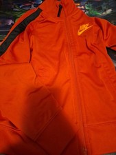 Nike Kids' Red full-zip track jacket with black trim.
