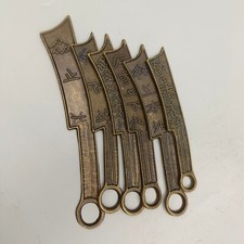 A set of six ancient coins, including knives and coins