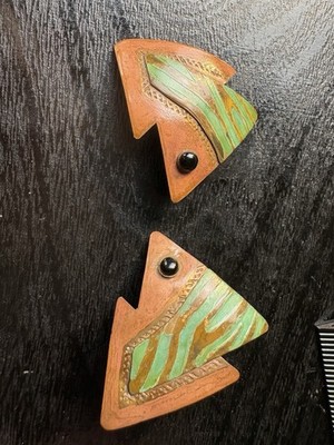 Artisan made copper earrings in the shape of fish with black stone eyes