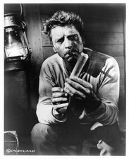Burt Lancaster looking at stick of dynamite in the film The Profes- Old Photo