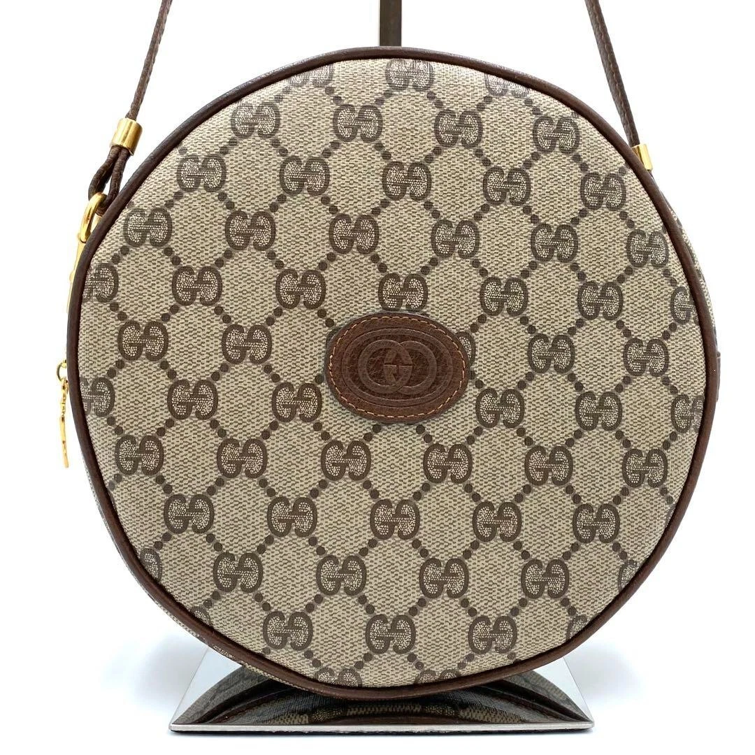 Gucci sac bandoulière GG suprême PVC cuir beige imbriqué logo en relief rond