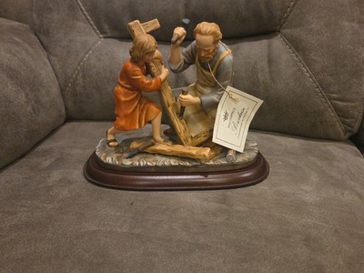 The Carpenter Figurine Representing Joseph Teaching A Young Jesus