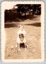 Vtg B&W Snapshot Two Young Boys Playing Horse Leapfrog In Grassy Field Circa