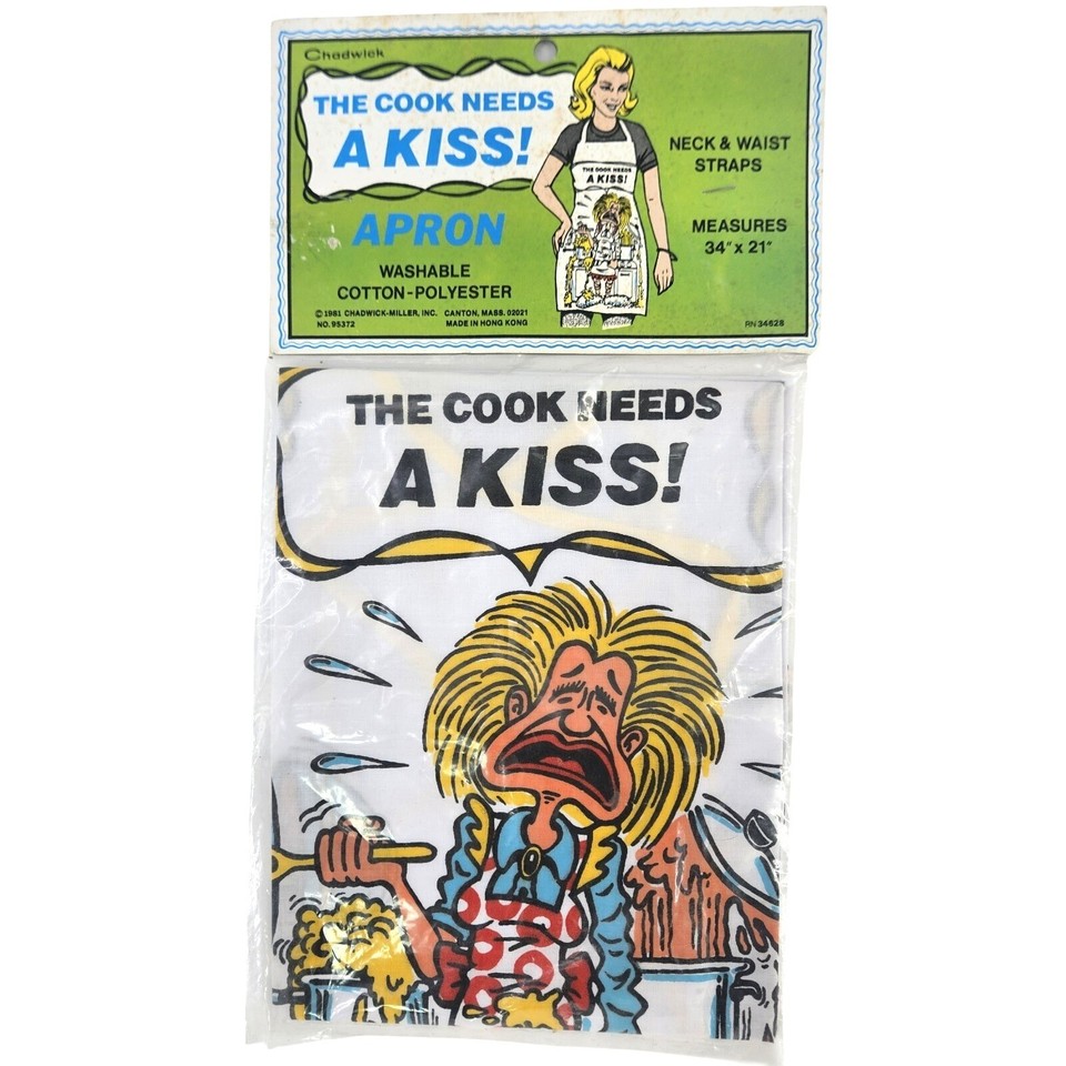 NOS 1981 novelty apron featuring a cartoon chef demanding a smooch — deadpan retro humor in pristine, never-used condition from over 40 years ago.