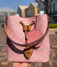 NWT Coach CEA23 Rowan Bucket Bag In Signature Canvas With Charms Powder Pink