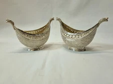 A fine pair of Kashmiri silver vessels in the form of kashkul begging bowls.