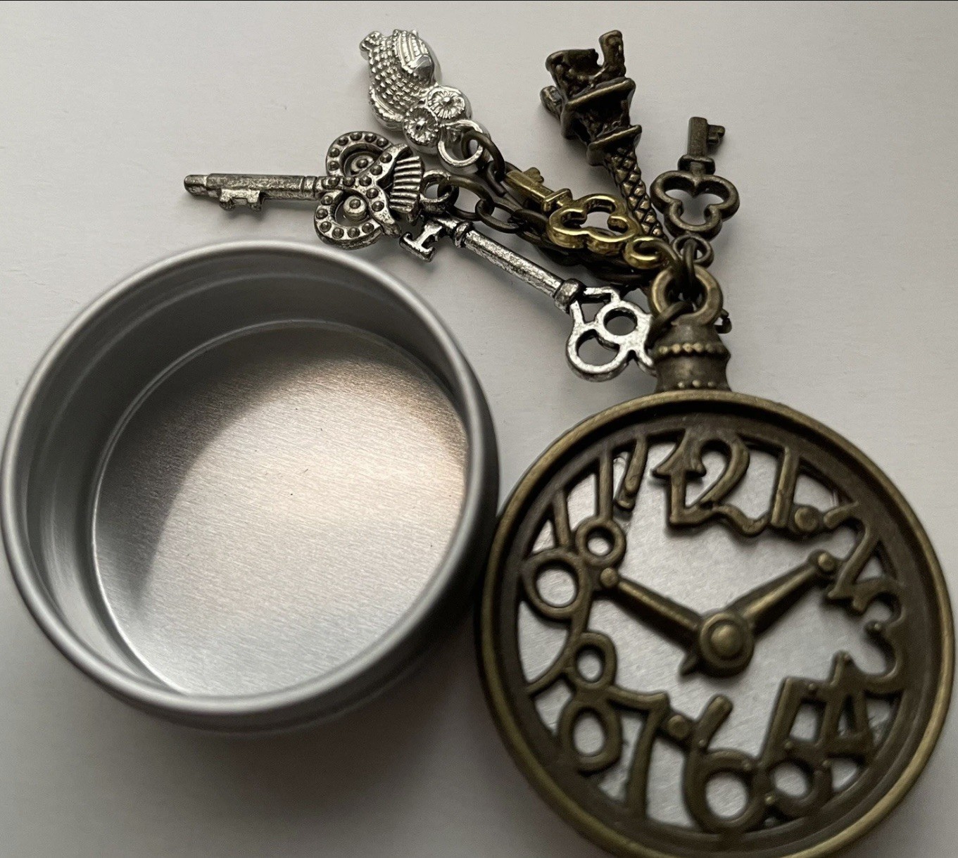Tiny round clock trinket keepsake tin with dangle… - image 1
