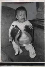 1956 Press Photo of Bonnie Majewski holding cake pan that stuck on her head.