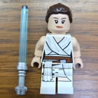 LEGO Star Wars Rey Minifigure, White Outfit, Brown Hair Bun & Blue Lightsaber