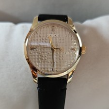 Gucci  G-Timeless Ladies Wristwatch Gold Dial Gold Case Black Leather Strap 