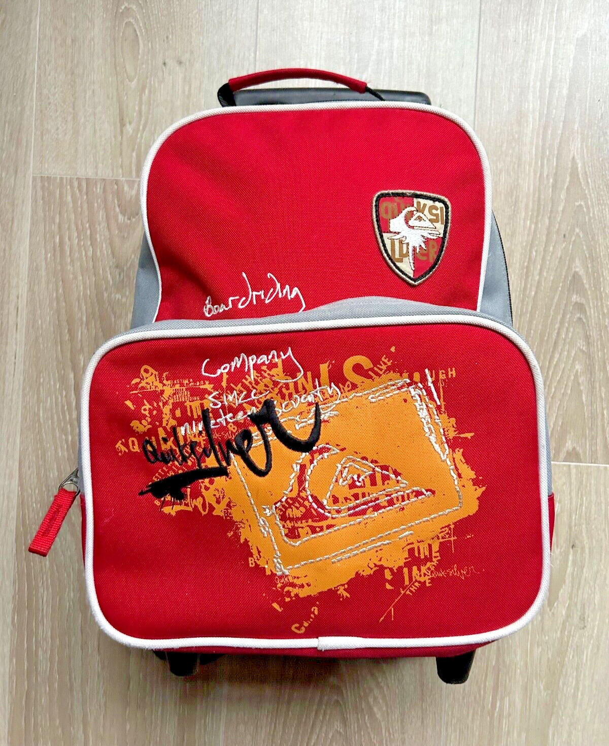 Mochila de viaje Quiksilver pequeña mini para niños con ruedas Billy Boarding roja