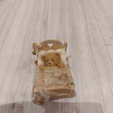 cherised teddy - baby in cot